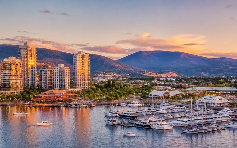 Downtown Kelowna North waterfront at golden hour — marina, condos, and Okanagan Lake views